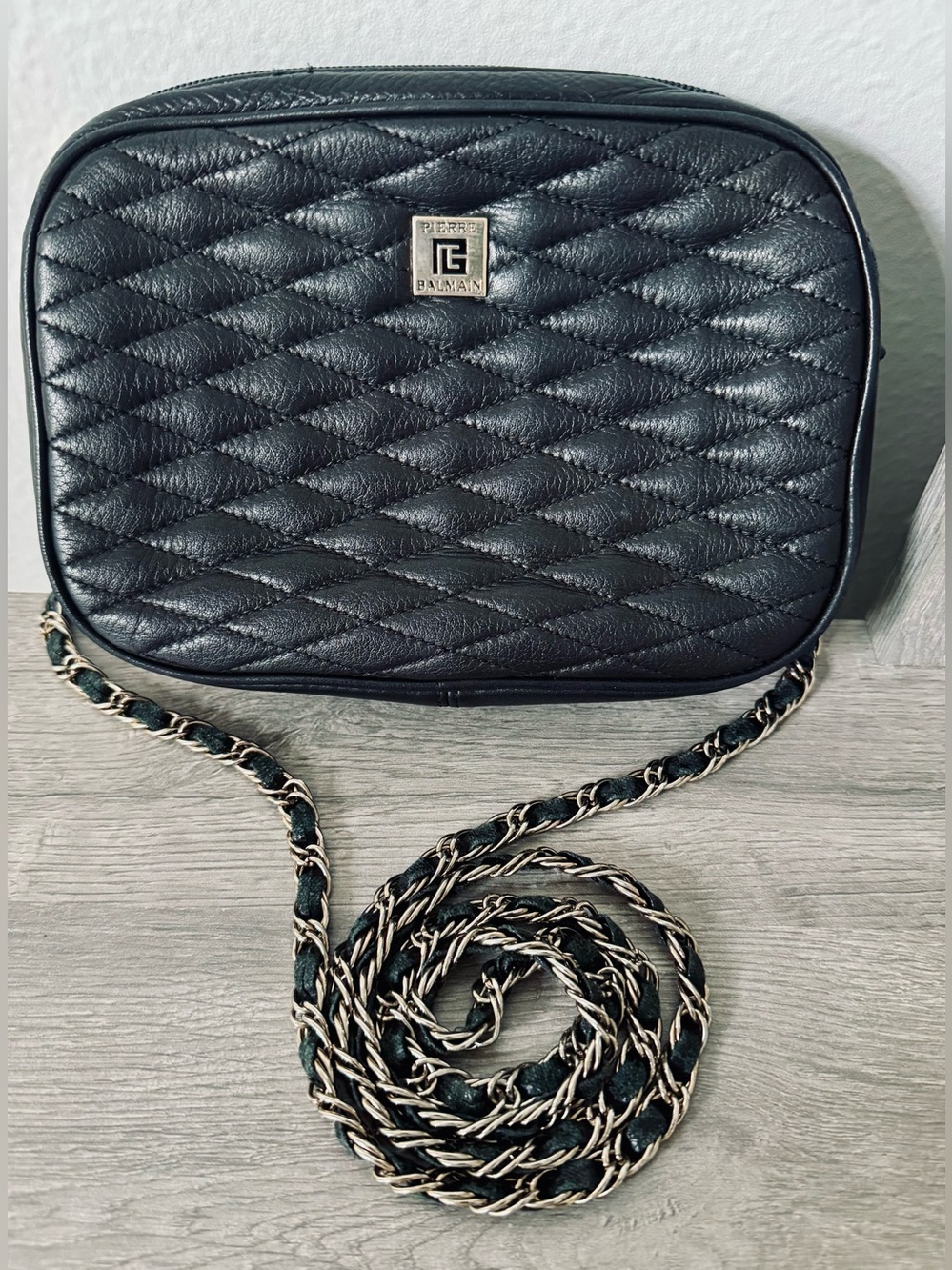 Vintage Pierre Balmain black leather quilted crossbody bag. The bag features